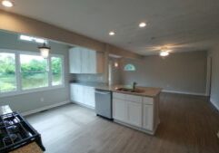 Kitchen with eat-at counter overhang. Open concept